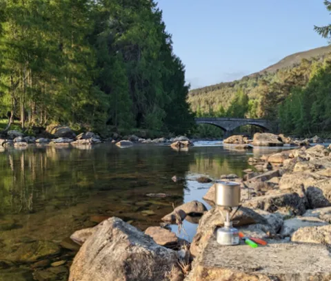 River with camping stove on stones in foreground. Photo credit: Rachel Helliwell River with camping stove on stones in foreground. Photo credit: Rachel Helliwell